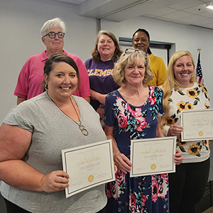 Group of six women holding leadership certificates